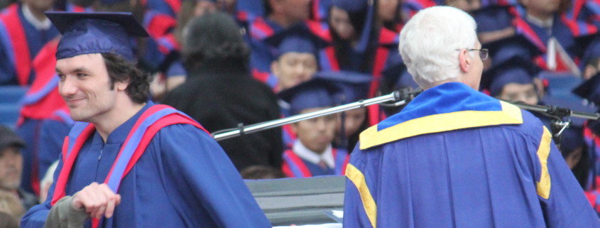 Vancouver Immigration Consultant CIP Canada - Smiling graduate walking off stage at ceremony