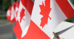 Vancouver Immigration Consultant CIP Canada - Line up of Canada Flags photo